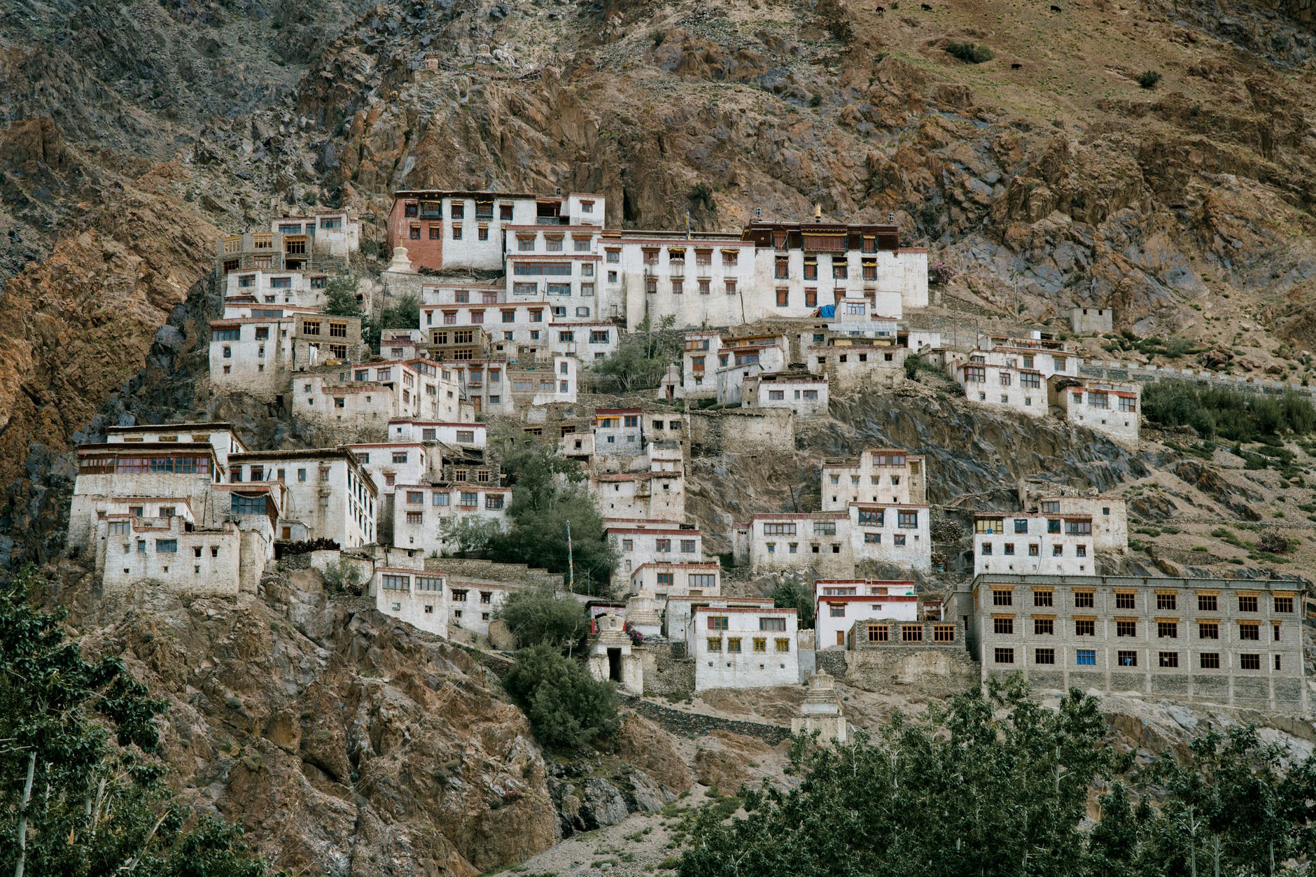 ancient tibetan monastery located on mountain slope in wild valley